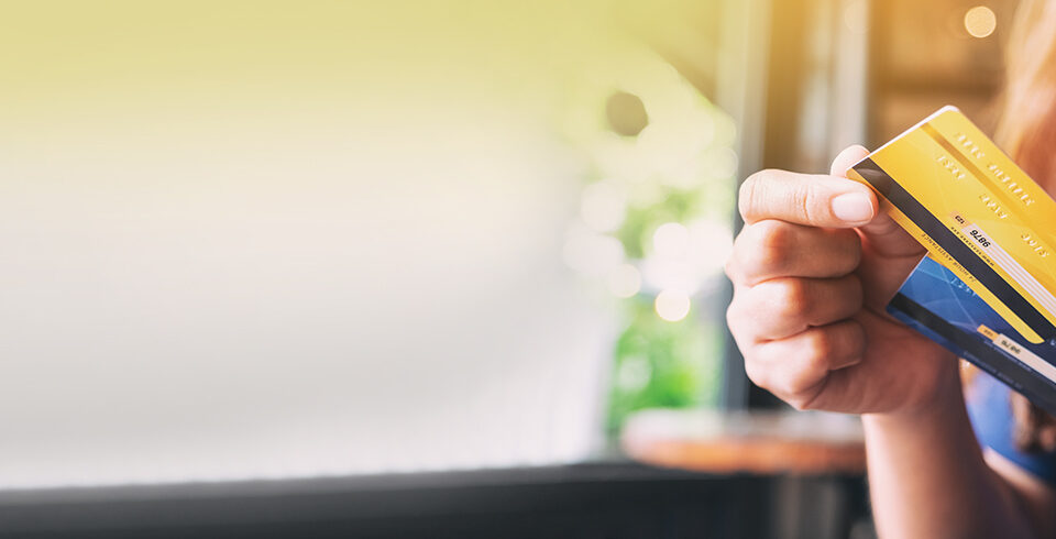 Closeup image of a woman holding and choosing credit card to use